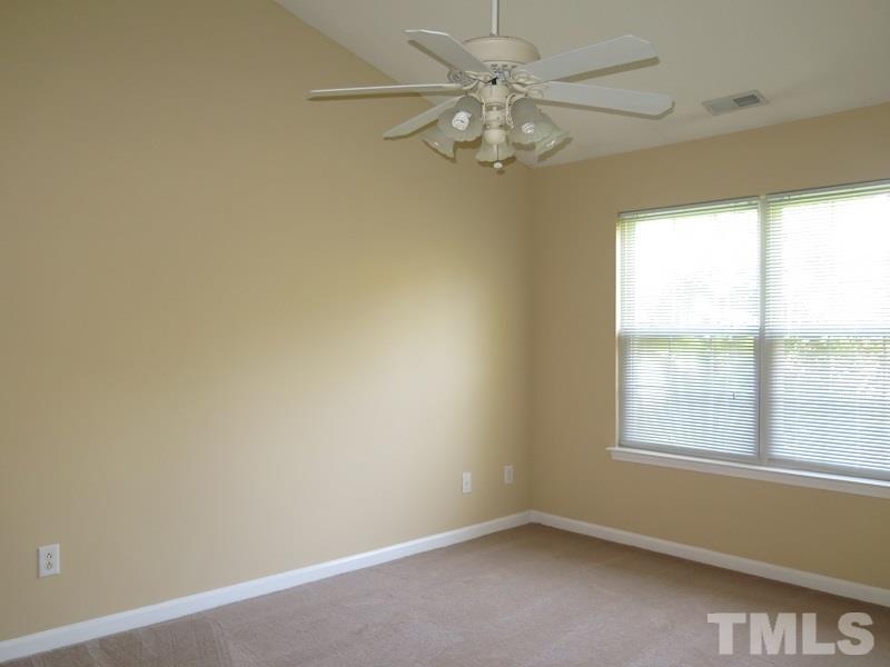 9136 Shallcross Way Raleigh, NC 27617 - Photo 7 of 13 an empty room with a window