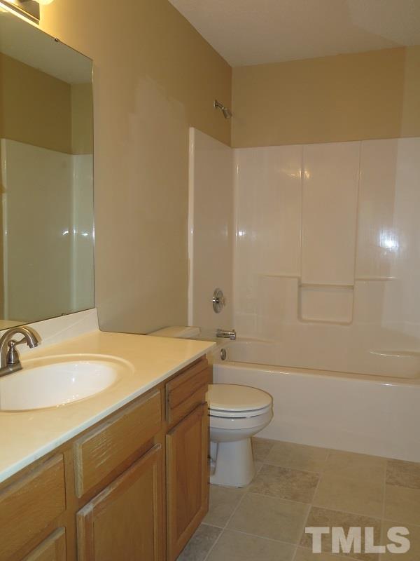 9136 Shallcross Way Raleigh, NC 27617 - Photo 8 of 13 a bathroom with a sink a toilet and shower