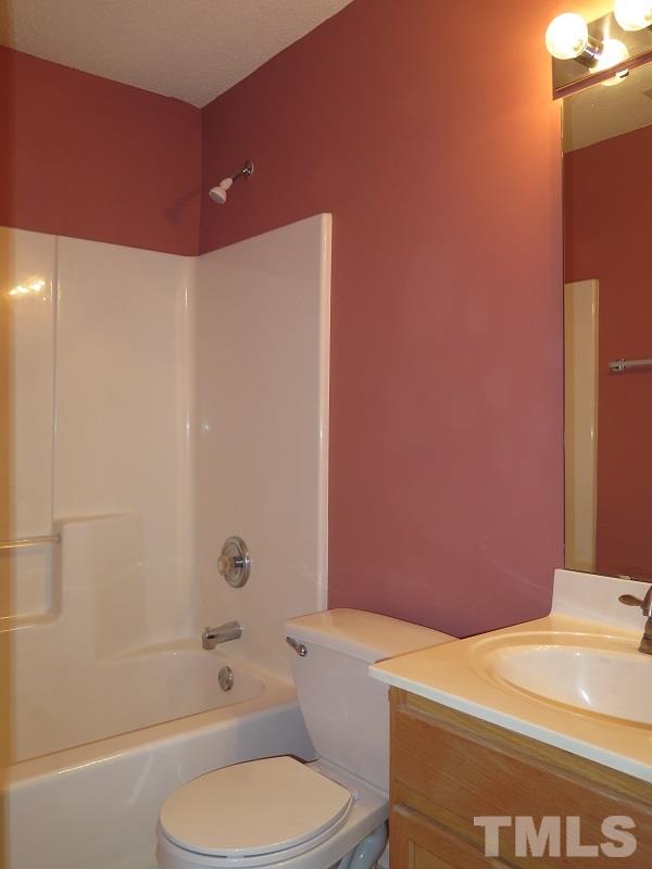 9136 Shallcross Way Raleigh, NC 27617 - Photo 10 of 13 a bathroom with a sink a toilet and shower