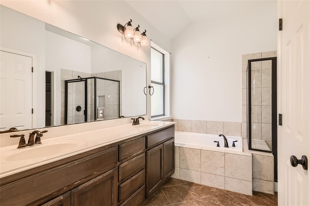 290 Maeves Way Austin, TX 78737 - Photo 8 of 13 Double vanity offers ample space, complementing the clean lines of the bath and glass-enclosed shower.