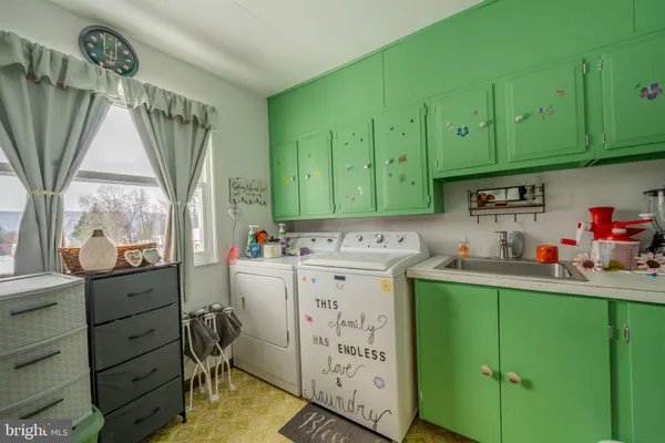 a kitchen with a sink cabinets and a window
