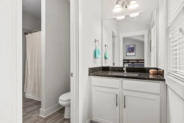 a backyard of a house with wooden floor table and chairs