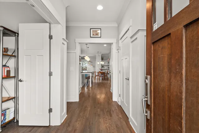 a view of a hallway with wooden floor and staircase