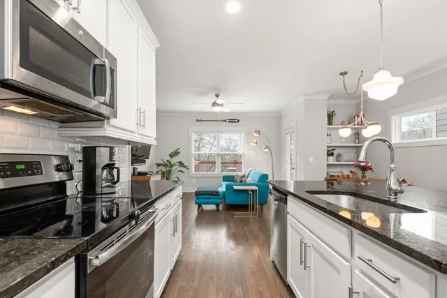 a kitchen with lots of counter top space a sink and appliances