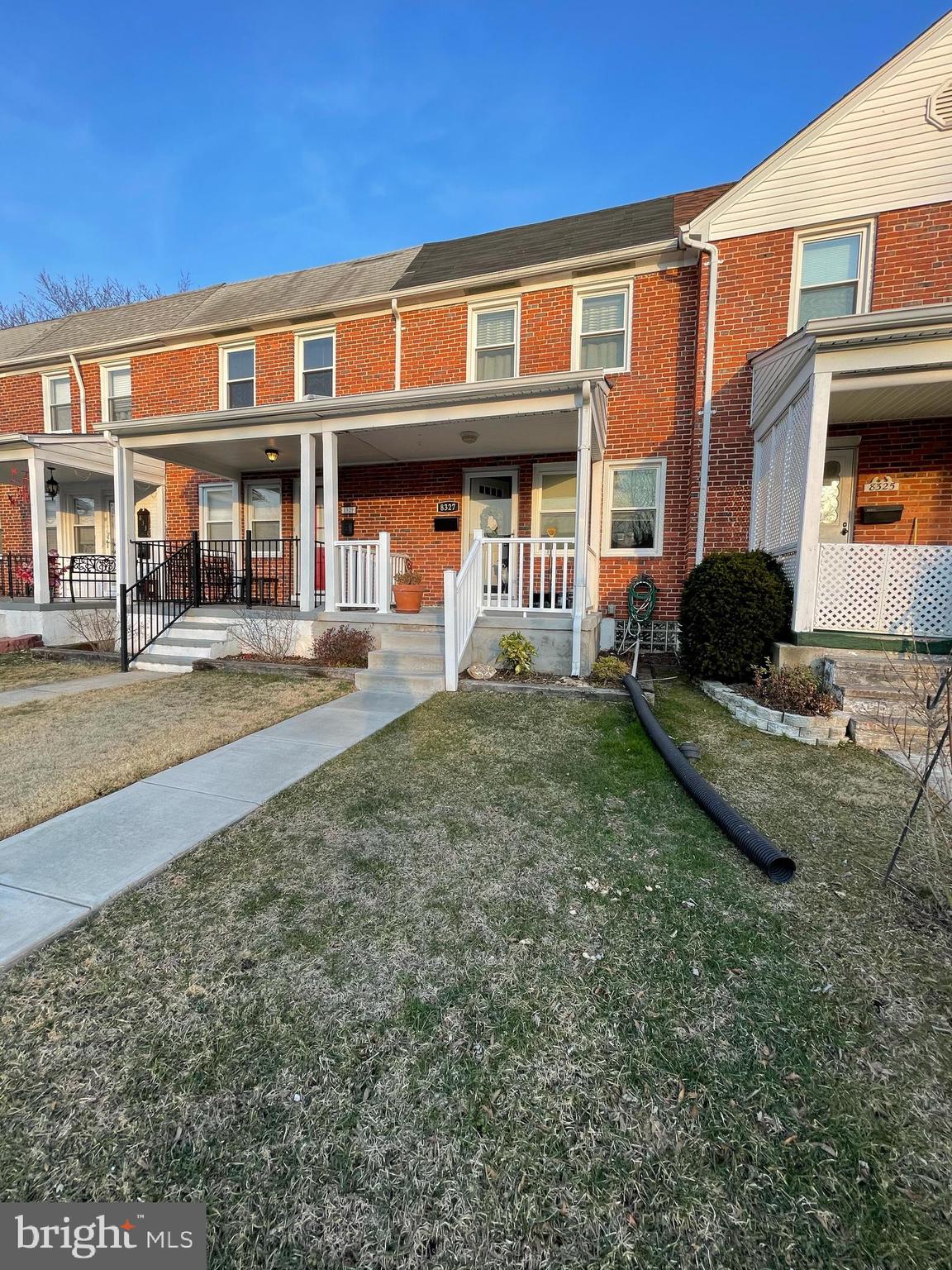 8327 Ridgely Oak Road Parkville, MD 21234 - Photo 3 of 5 a front view of a residential apartment building with a yard