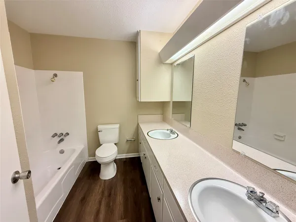 a view of storage and utility room with wooden floor