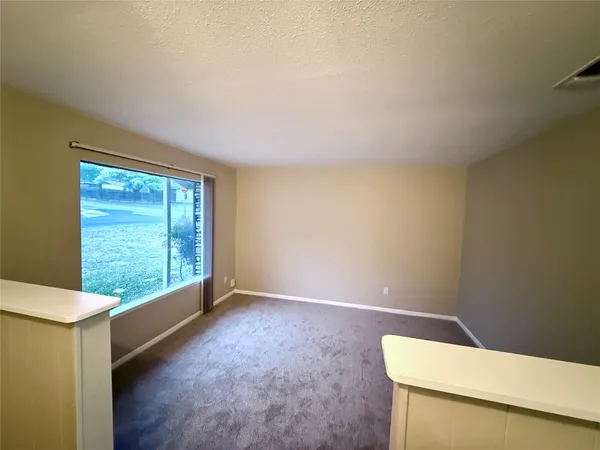 a view of a porch with furniture and a backyard