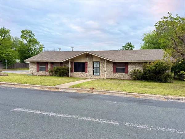 a view of a house with a swimming pool and a yard