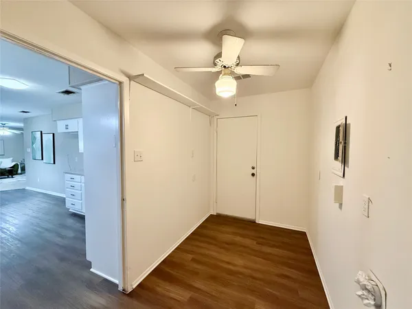 a spacious bedroom with a bed a couch and a flat screen tv