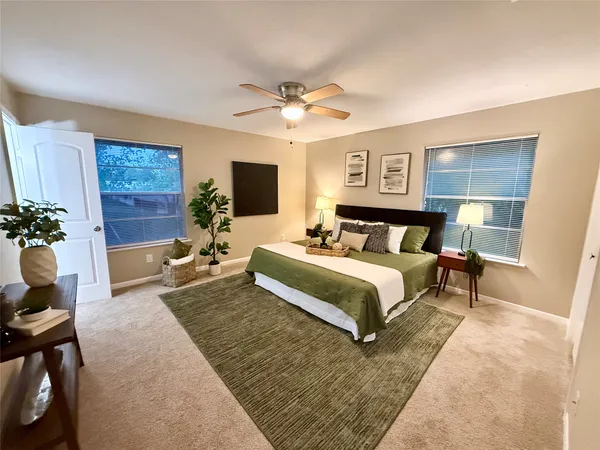 a bedroom with a bed and a potted plant