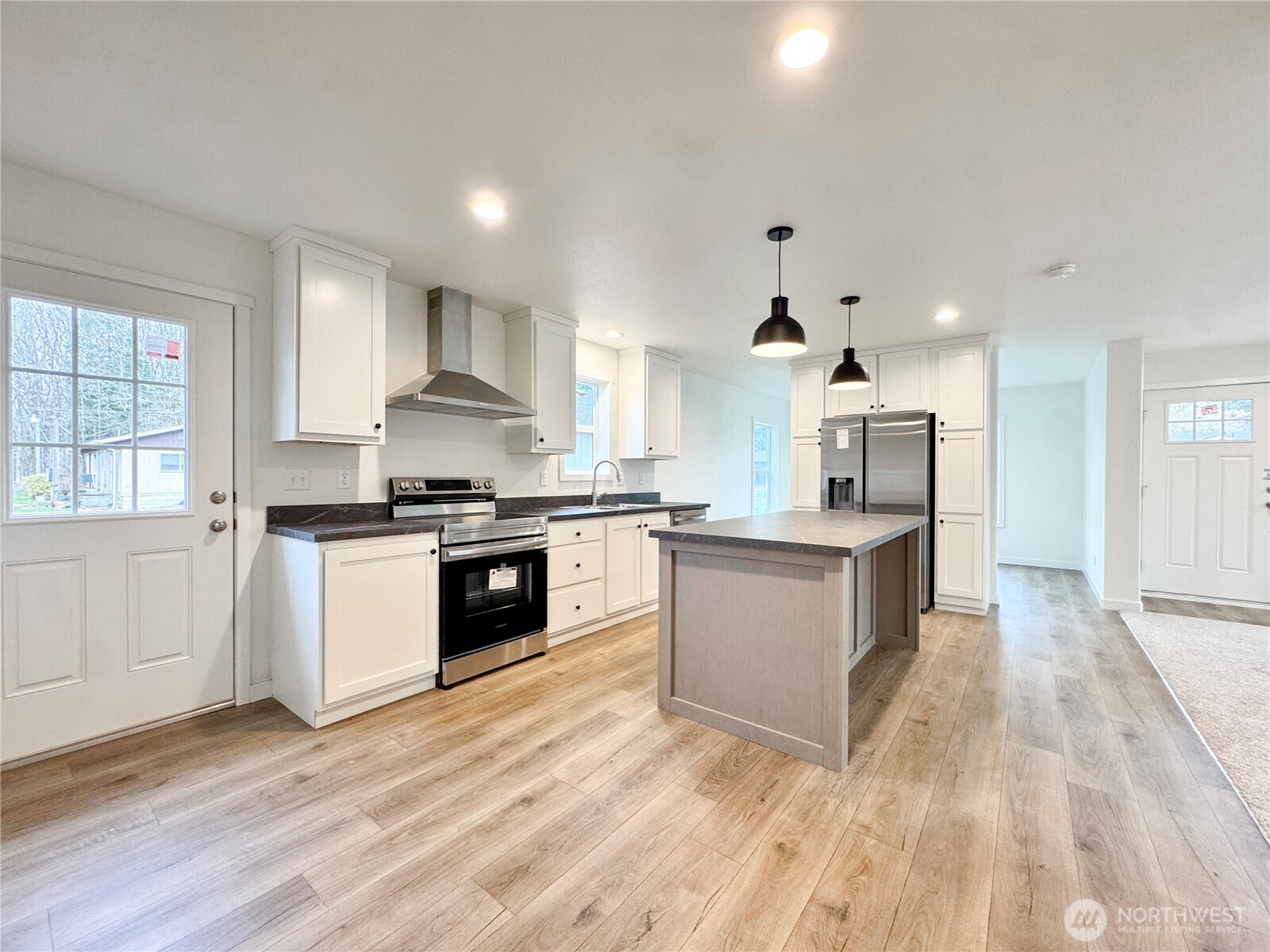 618 C Street Vader, WA 98593 - Photo 5 of 15 a large kitchen with stainless steel appliances granite countertop a stove and a sink