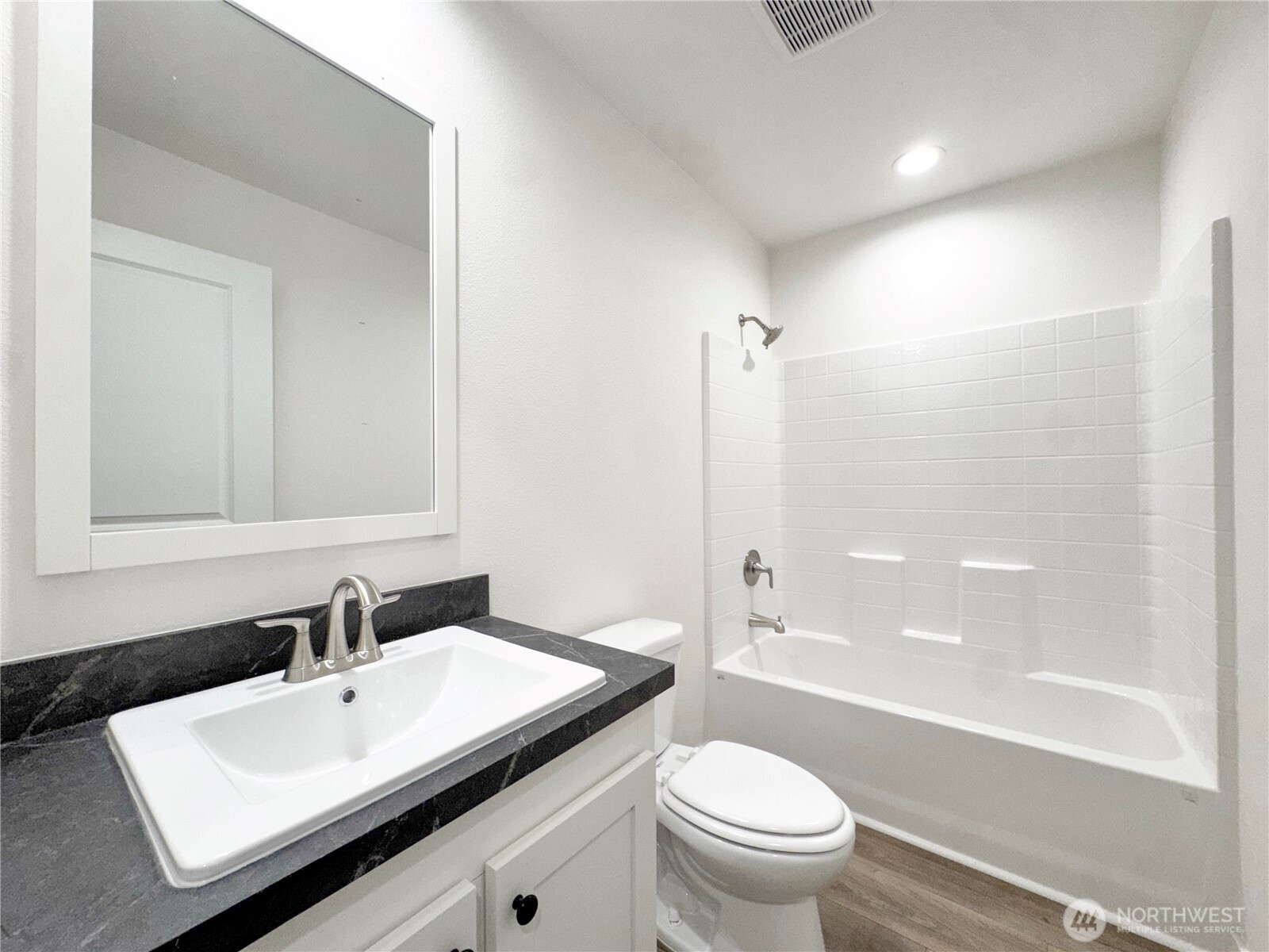 618 C Street Vader, WA 98593 - Photo 10 of 15 a bathroom with a sink a toilet and a large mirror
