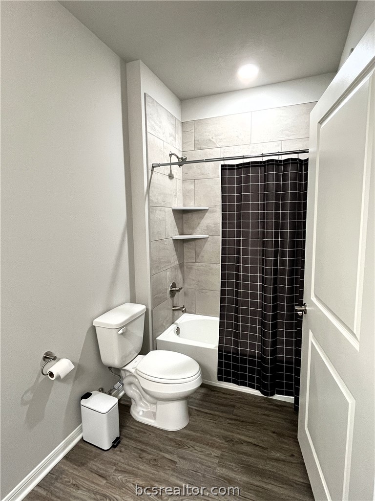 1326 Prairie Drive, Unit 1021 Bryan, TX 77803 - Photo 12 of 17 a white toilet sitting next to a bathroom sink
