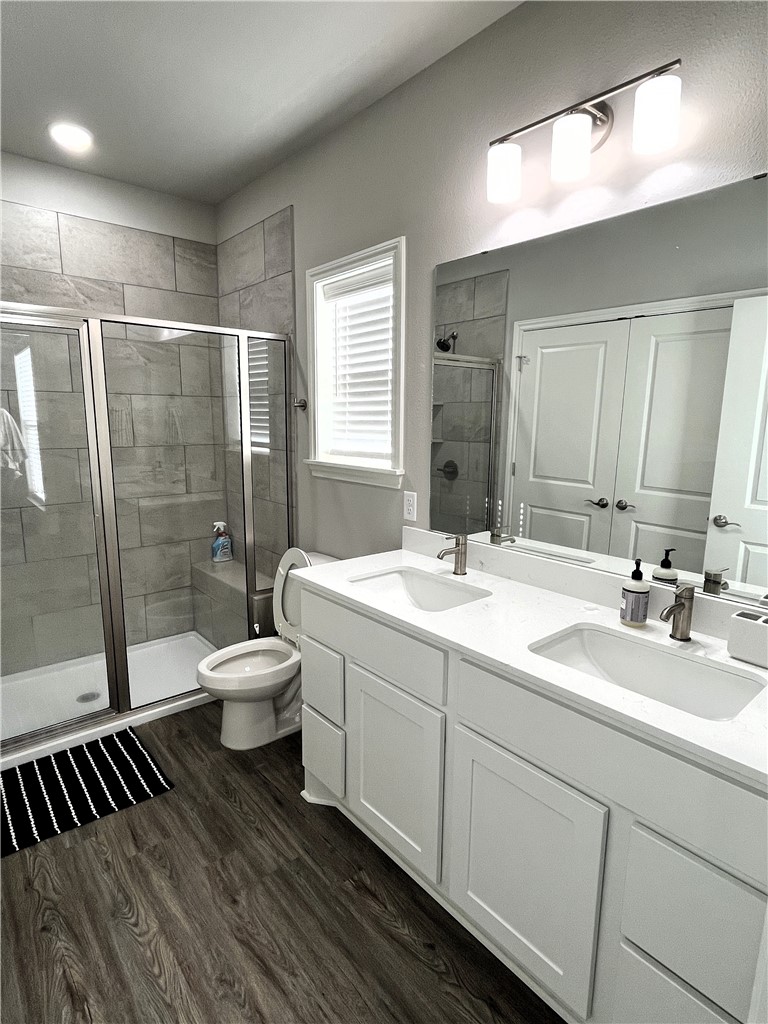1326 Prairie Drive, Unit 1021 Bryan, TX 77803 - Photo 14 of 17 a bathroom with a double vanity sink toilet and shower