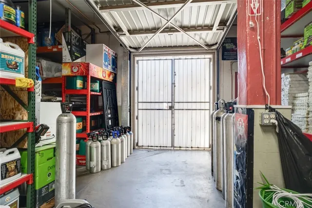 a kitchen with stainless steel appliances kitchen island granite countertop a refrigerator a stove a sink dishwasher and white cabinets with wooden floor