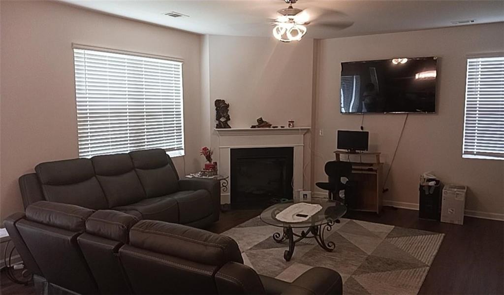 1033 Eldon Lane Fairburn, GA 30213 - Photo 10 of 21 a living room with furniture a flat screen tv and a window