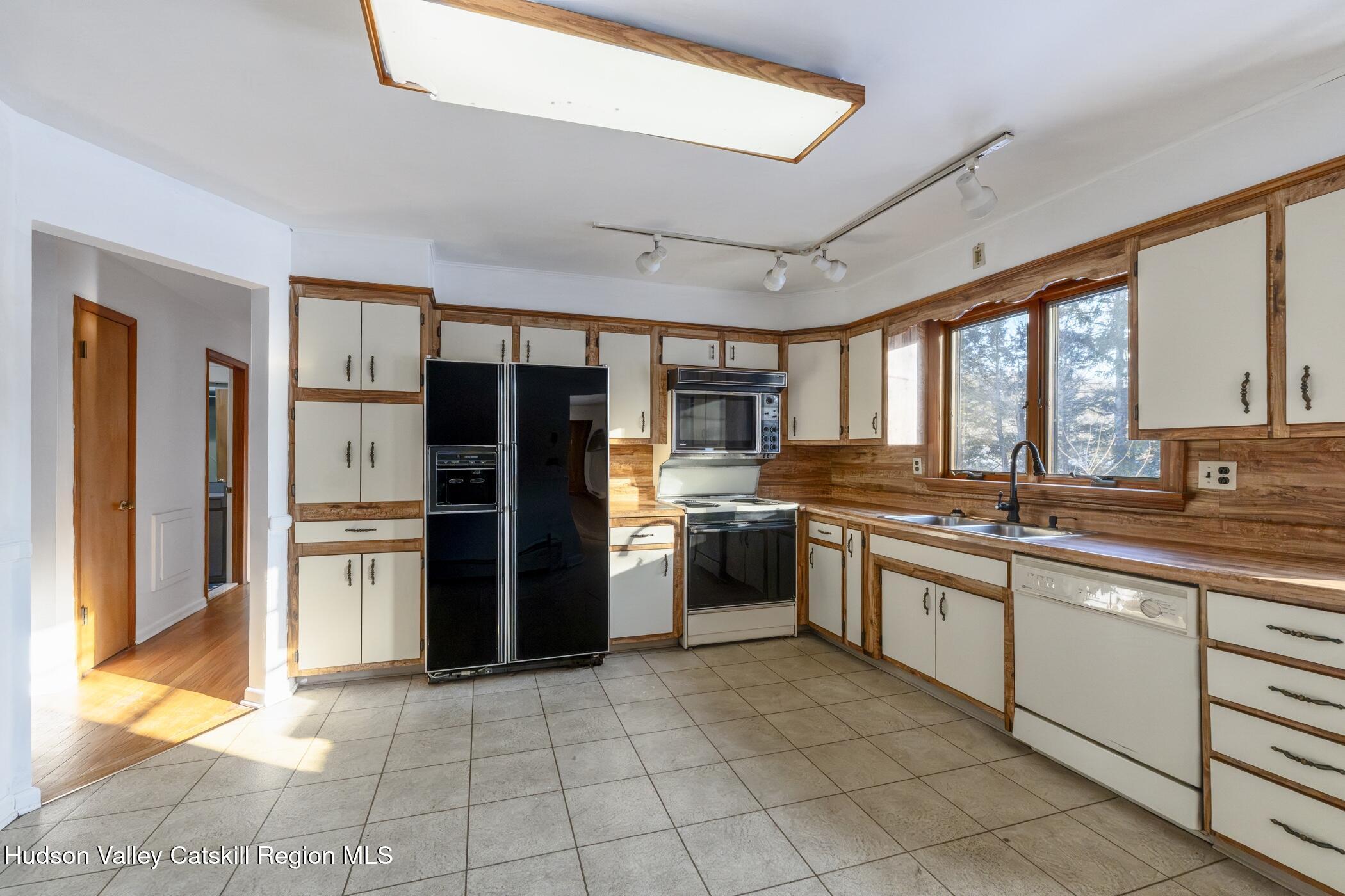 609 New Paltz Road Highland, NY 12528 - Photo 11 of 35 a large kitchen with a large window and stainless steel appliances