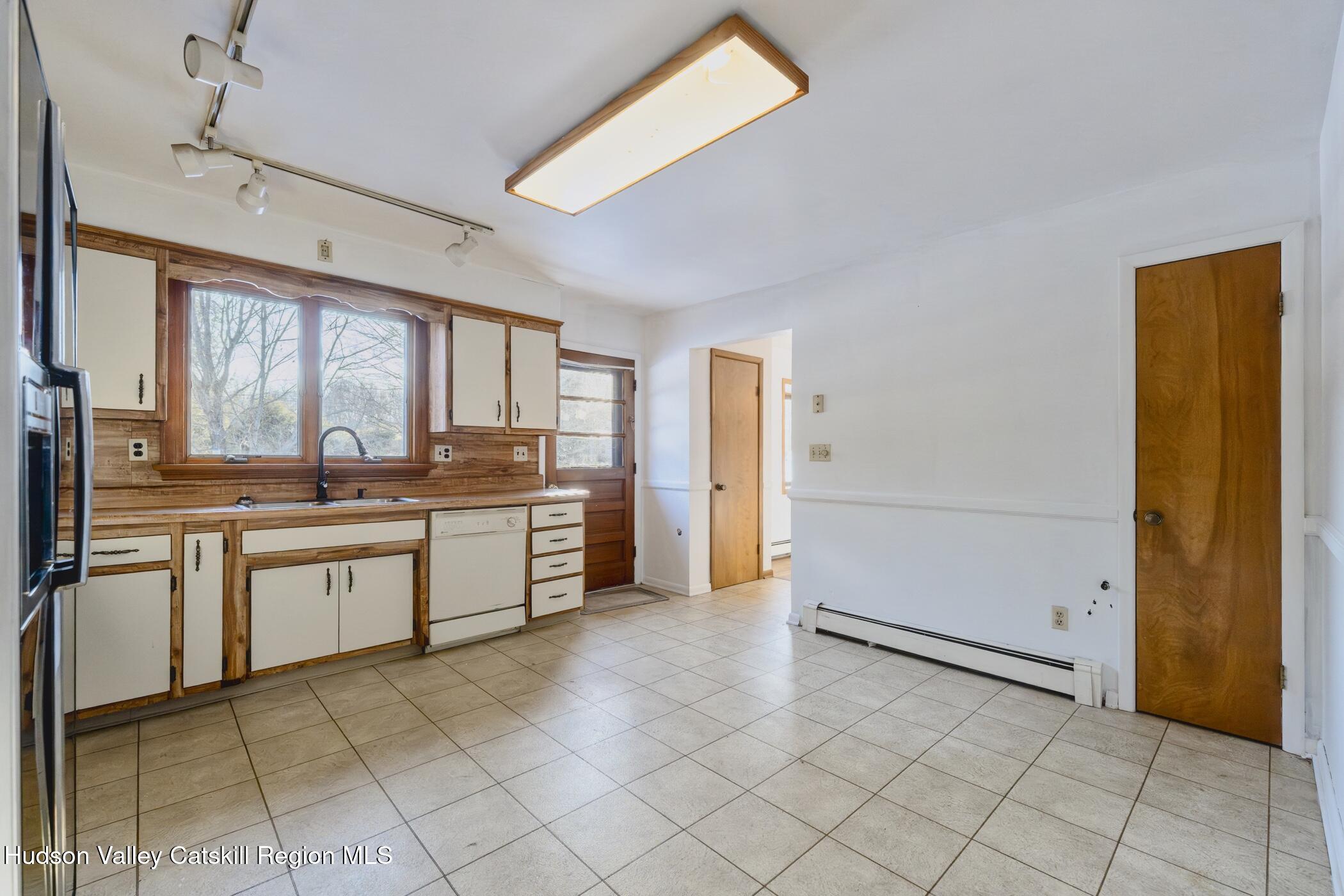609 New Paltz Road Highland, NY 12528 - Photo 12 of 35 a kitchen with stainless steel appliances a stove a sink and a refrigerator