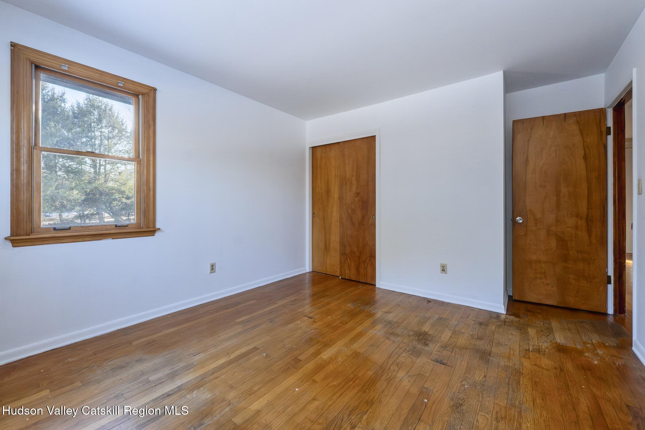 609 New Paltz Road Highland, NY 12528 - Photo 15 of 35 a view of an empty room with wooden floor and a window