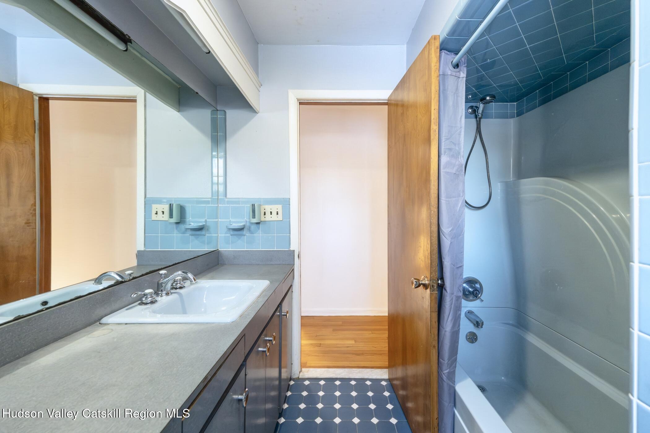 609 New Paltz Road Highland, NY 12528 - Photo 17 of 35 a bathroom with a granite countertop sink a mirror and shower