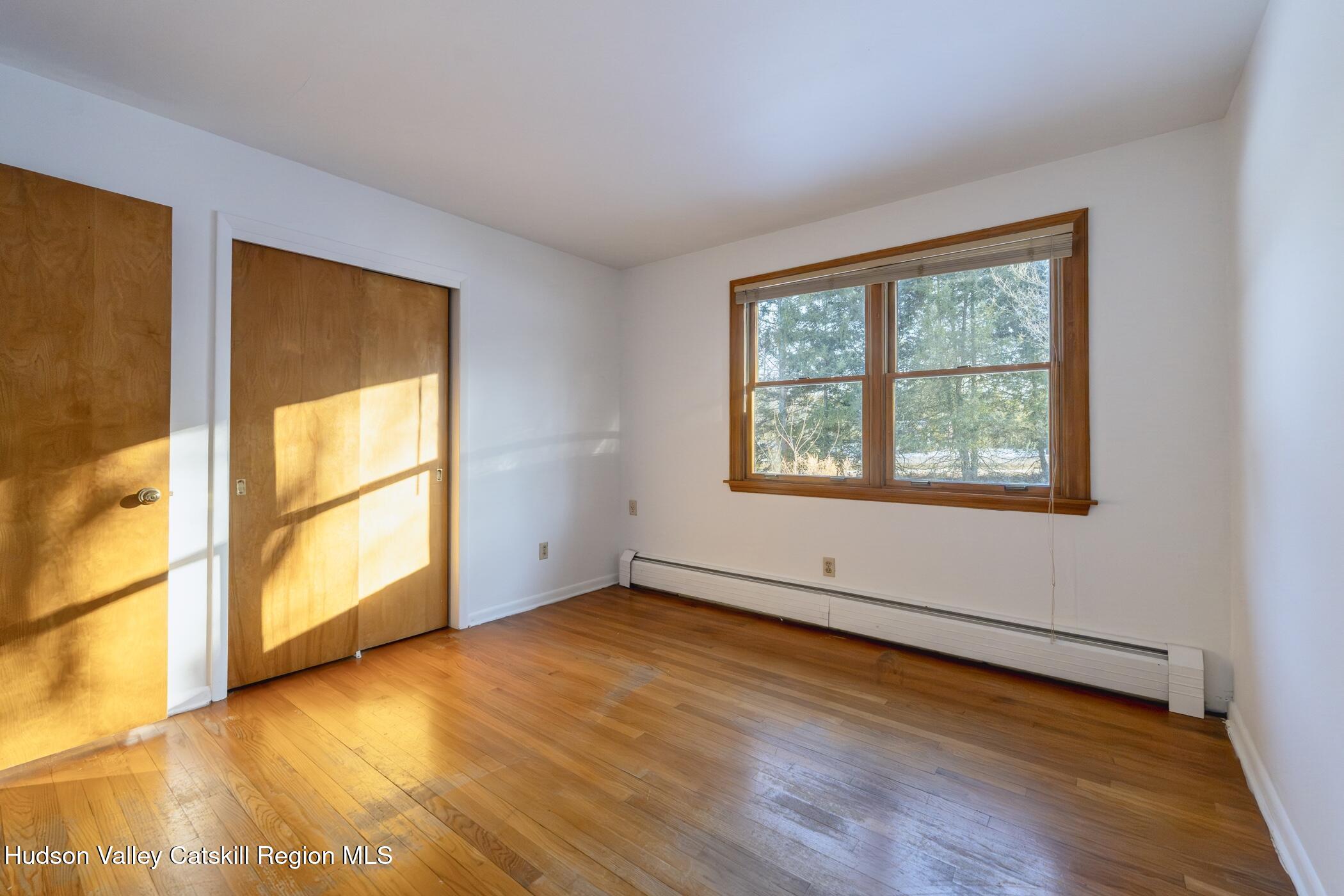 609 New Paltz Road Highland, NY 12528 - Photo 18 of 35 a view of an empty room with wooden floor and a window