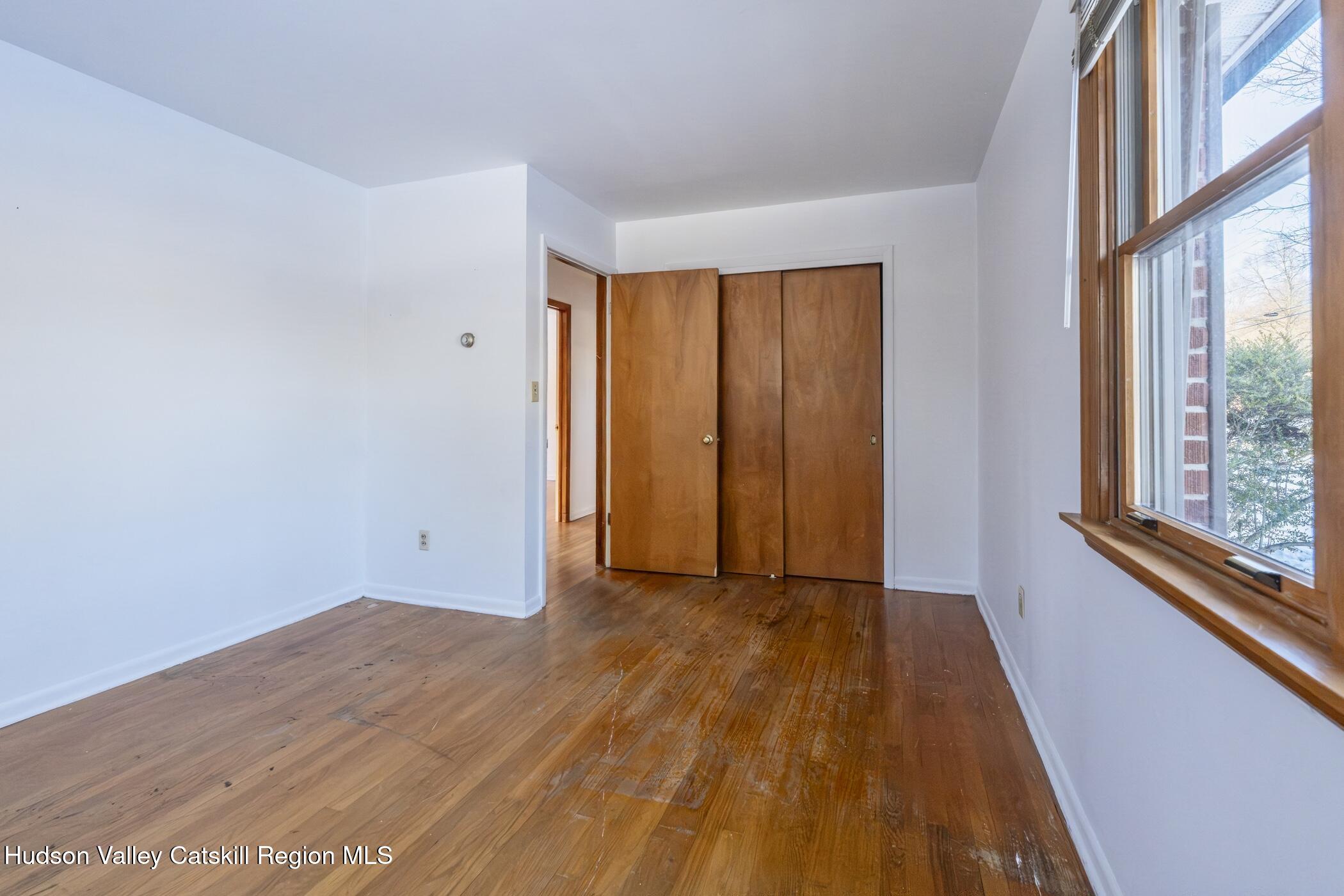 609 New Paltz Road Highland, NY 12528 - Photo 20 of 35 a view of an empty room with wooden floor and a window