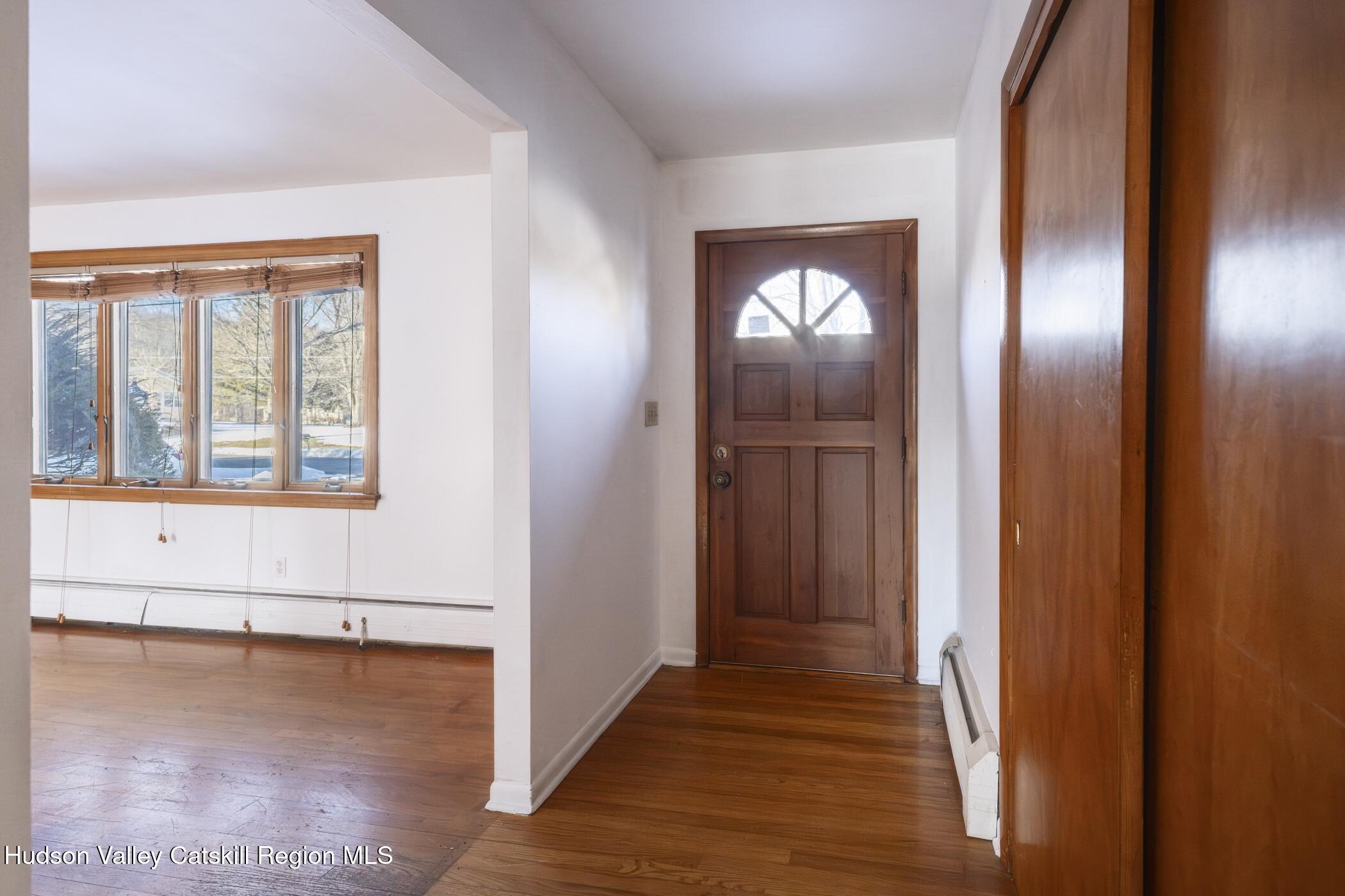 609 New Paltz Road Highland, NY 12528 - Photo 4 of 35 a view of an empty room with wooden floor and a window