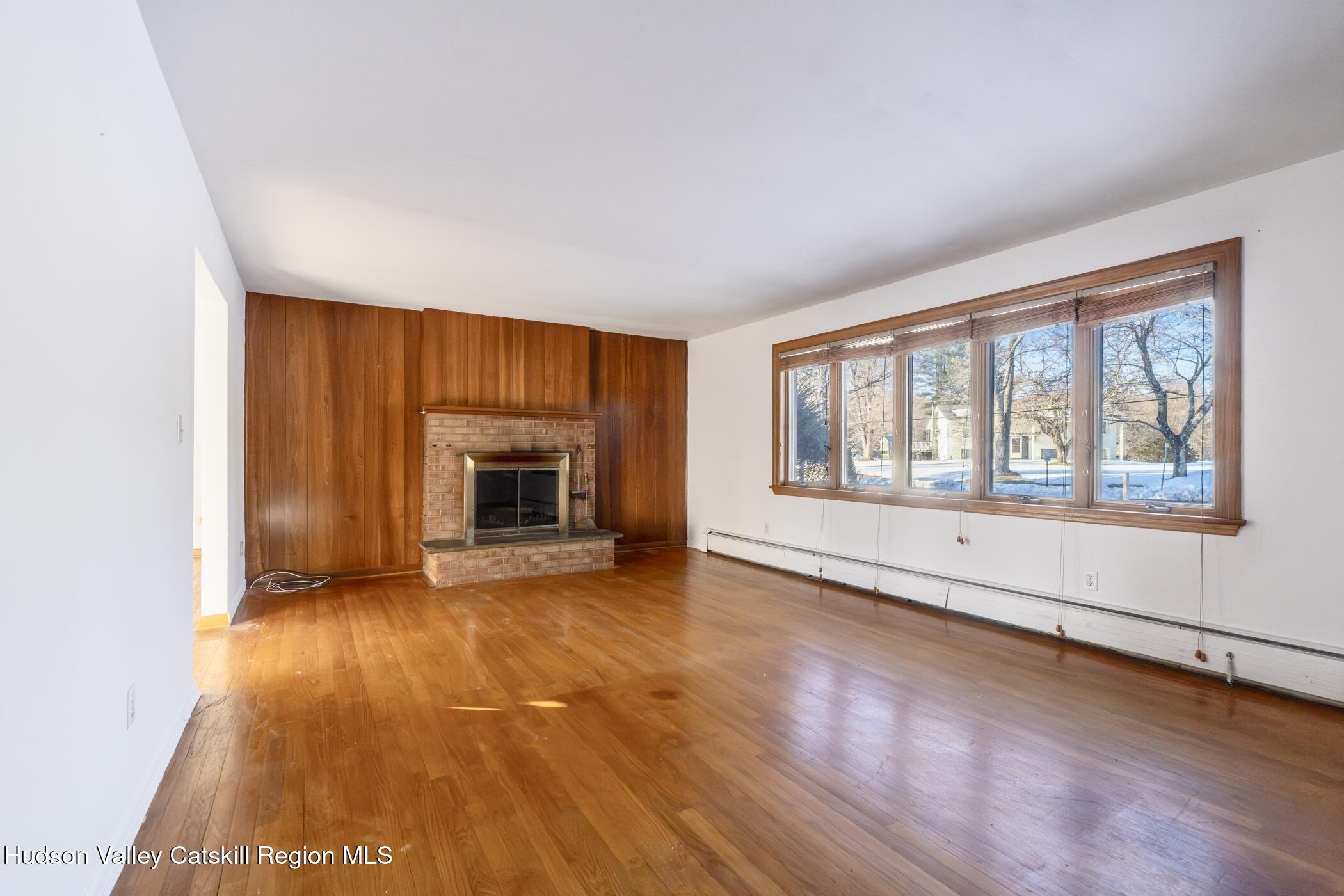 609 New Paltz Road Highland, NY 12528 - Photo 5 of 35 an empty room with wooden floor and windows