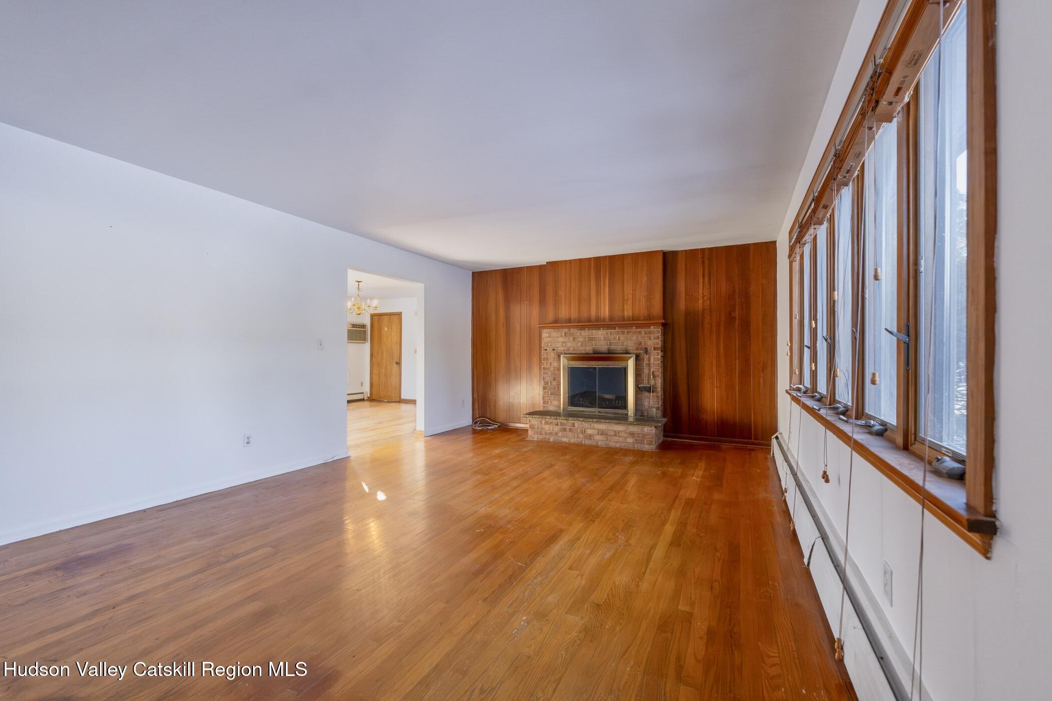 609 New Paltz Road Highland, NY 12528 - Photo 6 of 35 a view of an empty room with wooden floor and a window