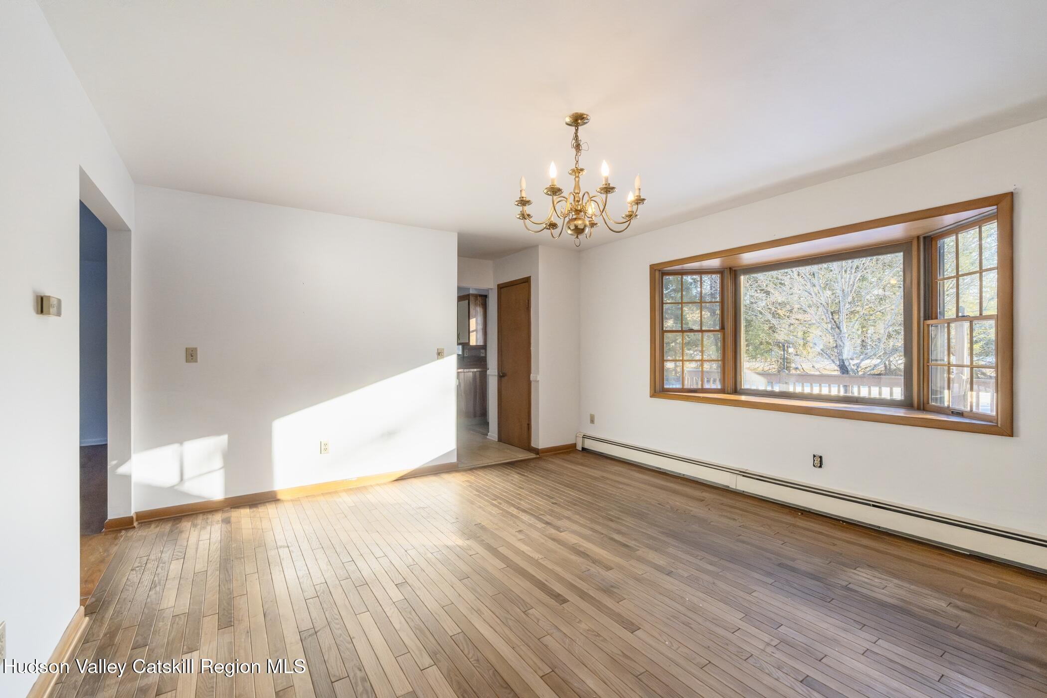 609 New Paltz Road Highland, NY 12528 - Photo 9 of 35 a view of an empty room with wooden floor and a window