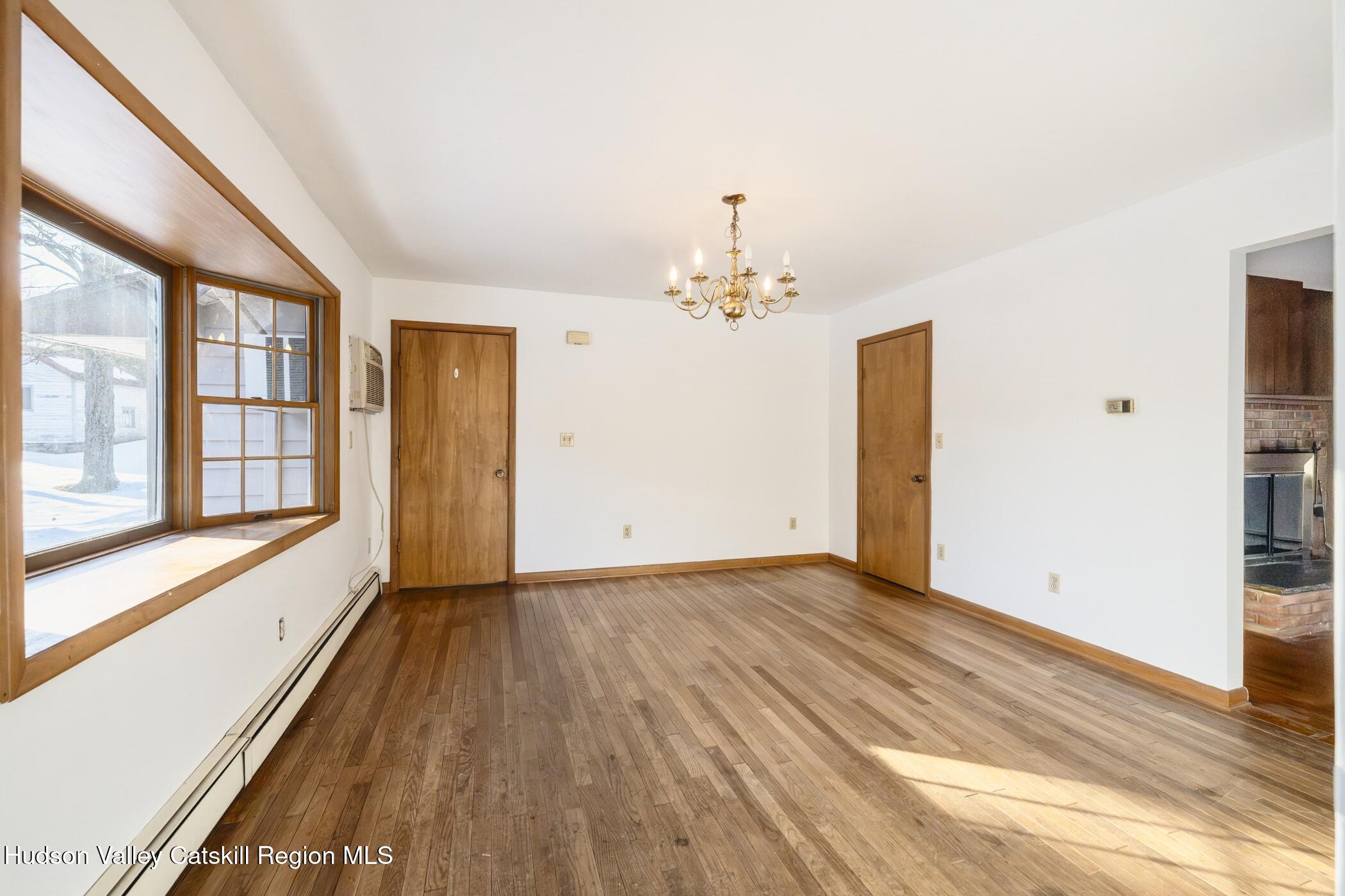 609 New Paltz Road Highland, NY 12528 - Photo 10 of 35 a view of an empty room with a window and wooden floor