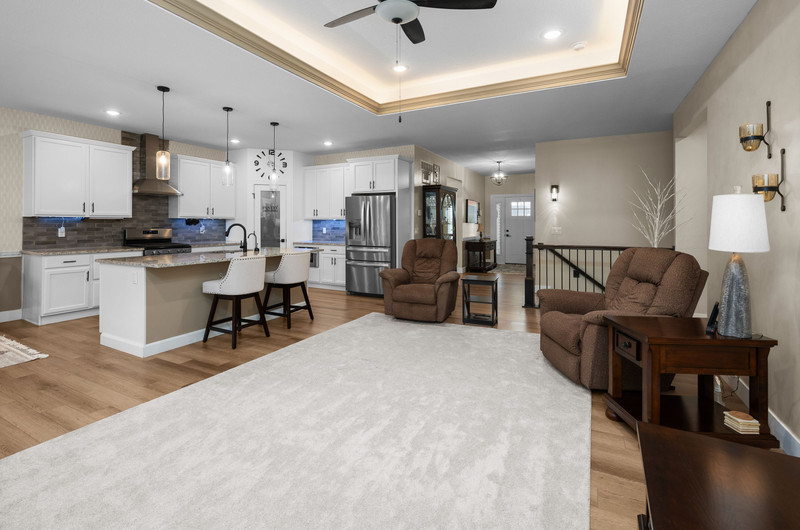 4418 Chestnut Drive Bettendorf, IA 52722 - Photo 12 of 45 a living room with furniture a dining table and chairs in it