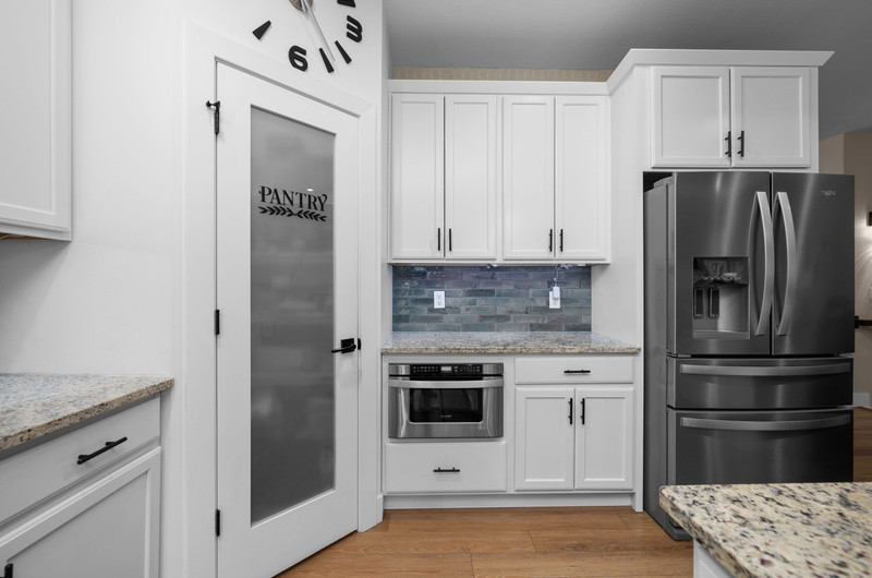 4418 Chestnut Drive Bettendorf, IA 52722 - Photo 18 of 45 a kitchen with stainless steel appliances granite countertop a refrigerator and a stove