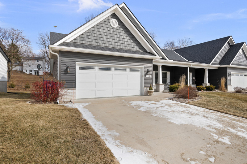 4418 Chestnut Drive Bettendorf, IA 52722 - Photo 2 of 45 a front view of a house with a garage