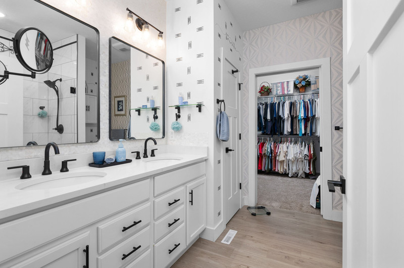 4418 Chestnut Drive Bettendorf, IA 52722 - Photo 27 of 45 a bathroom with a double vanity sink a mirror and shower