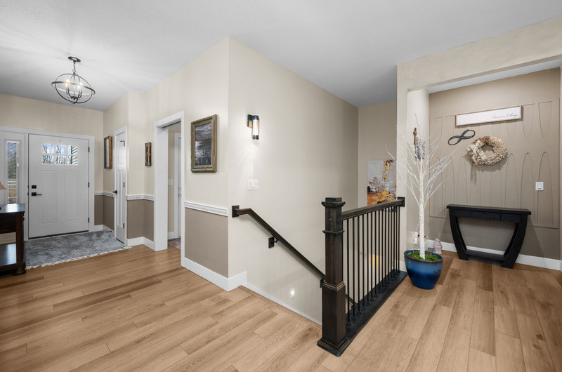 4418 Chestnut Drive Bettendorf, IA 52722 - Photo 10 of 45 a view of a hallway with wooden floor and staircase
