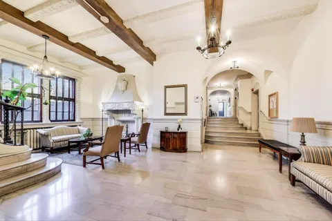 a living room with furniture fireplace and a chandelier