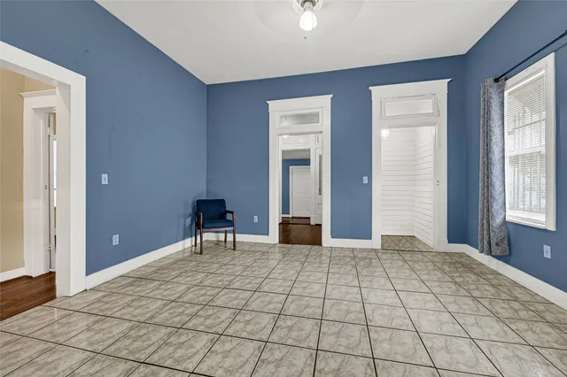 a view of a room with a lounge chair and windows