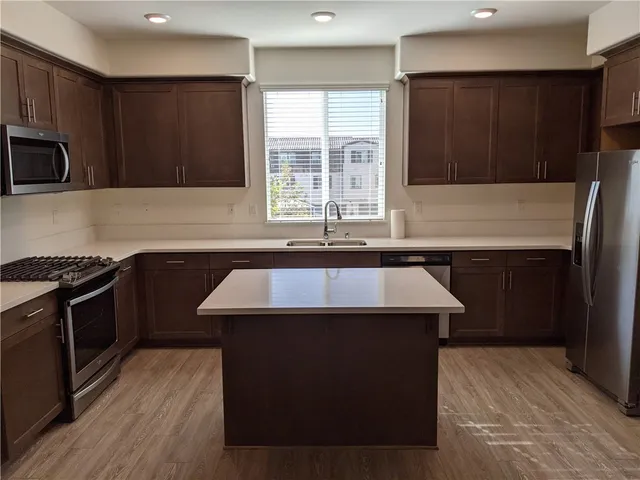 a kitchen with a sink and a stove top oven