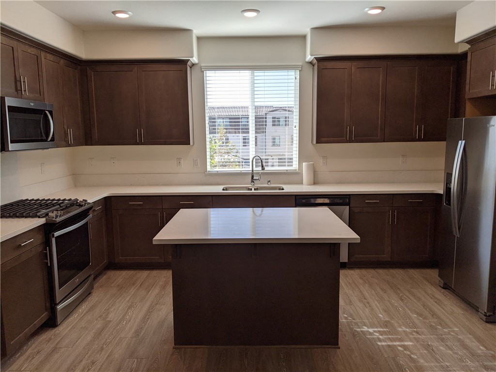 12248 Estrella Drive Rancho Cucamonga, CA 91739 - Photo 3 of 26 a kitchen with a sink and a stove top oven