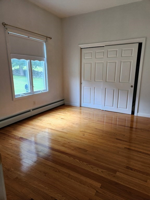 23 Case Drive Little Compton, RI 02837 - Photo 14 of 24 a view of an empty room with wooden floor and a window