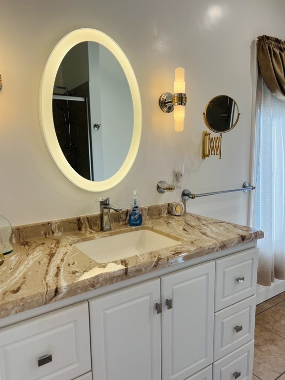 23 Case Drive Little Compton, RI 02837 - Photo 17 of 24 a bathroom with a granite countertop sink and mirror