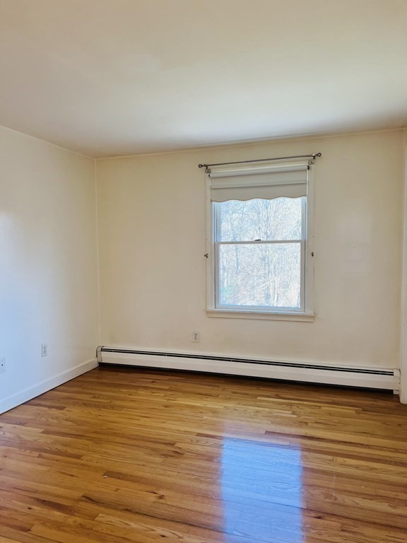 23 Case Drive Little Compton, RI 02837 - Photo 20 of 24 an empty room with wooden floor and windows