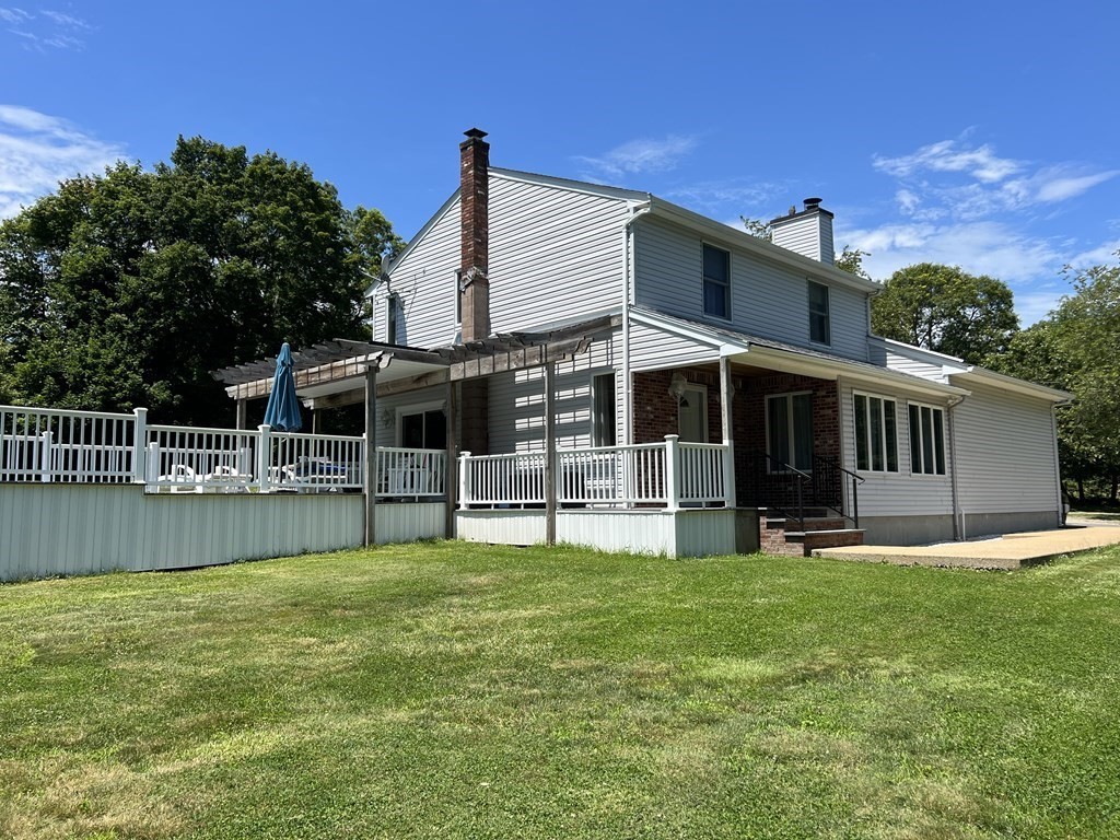 23 Case Drive Little Compton, RI 02837 - Photo 2 of 24 a view of a house with a yard and sitting area