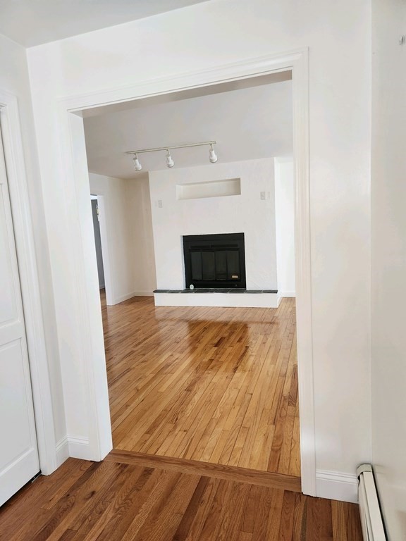 23 Case Drive Little Compton, RI 02837 - Photo 7 of 24 a view of a livingroom with wooden floor and a fireplace