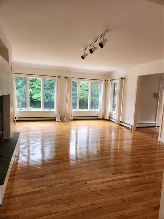 23 Case Drive Little Compton, RI 02837 - Photo 8 of 24 a view of empty room with wooden floor and fan