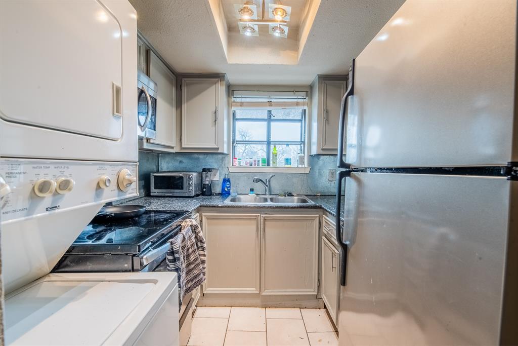 3506 Speedway, Unit 301C Austin, TX 78705 - Photo 1 of 8 a kitchen with stainless steel appliances granite countertop a sink stove and refrigerator