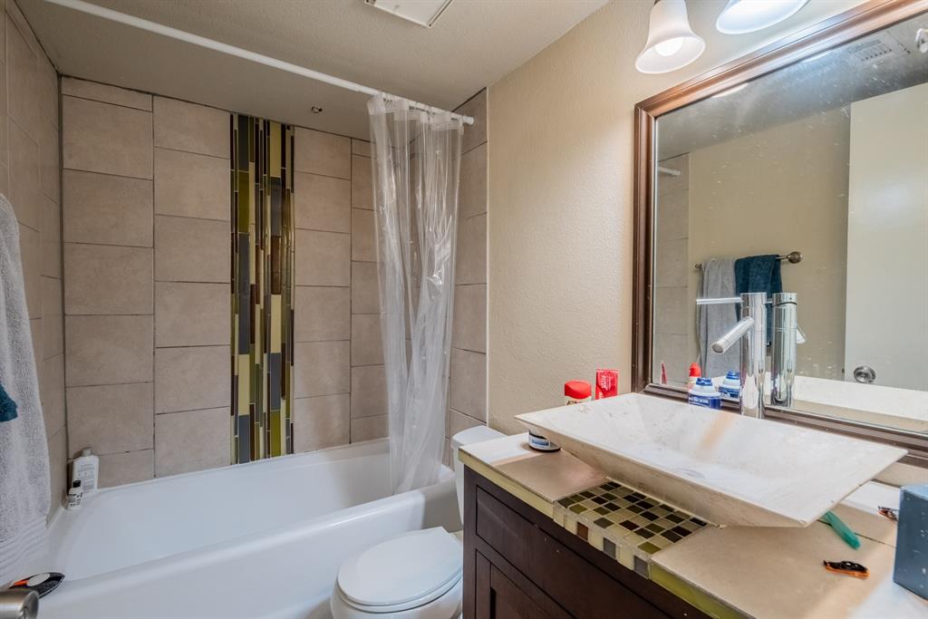 3506 Speedway, Unit 301C Austin, TX 78705 - Photo 5 of 8 a bathroom with a granite countertop sink and a mirror