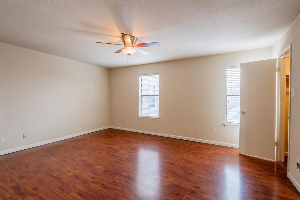 3506 Speedway, Unit 301C Austin, TX 78705 - Photo 6 of 8 an empty room with wooden floor fan and windows