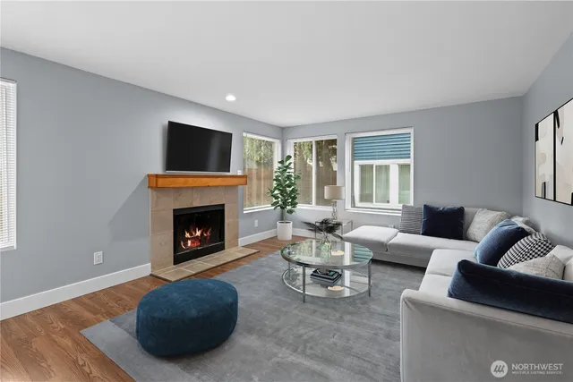 a living room with furniture a fireplace and a flat screen tv